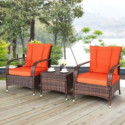 Three-piece wicker patio furniture set with glass table